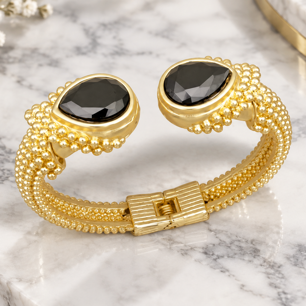 MX Dottie Bangle bracelet with pear-shaped stones, featuring a stylish design and elegant metallic finish.