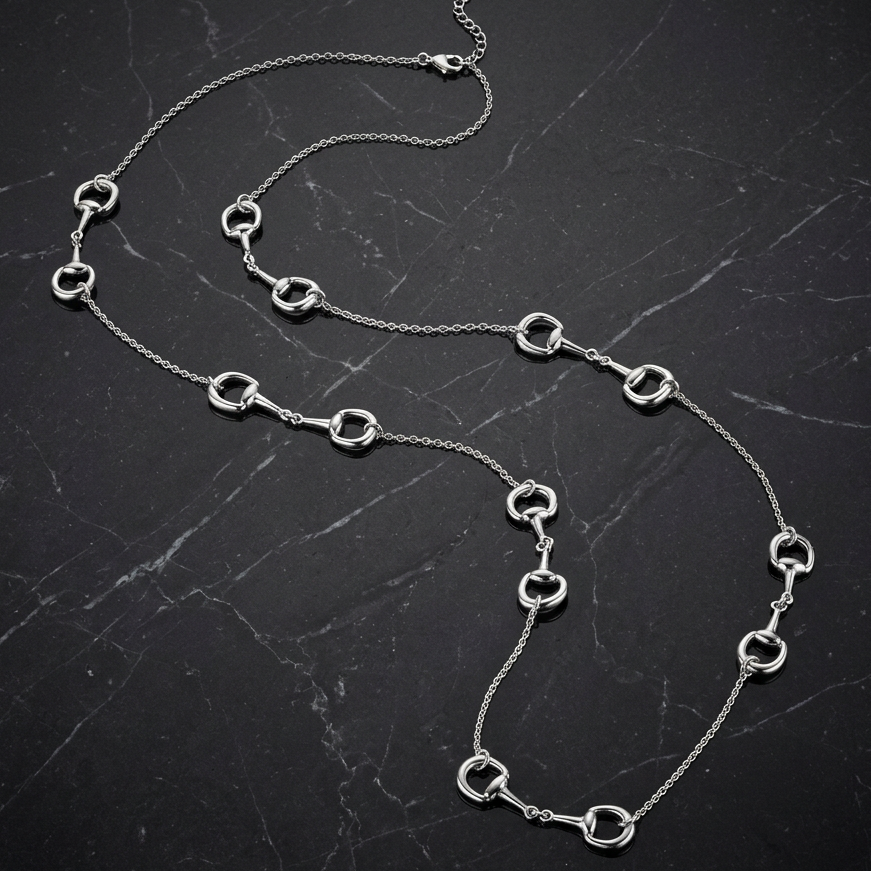 Joseph Anthony Inc. 7-Station Horse Bit Necklace, 36-inch gold-tone chain with decorative horse bit accents.