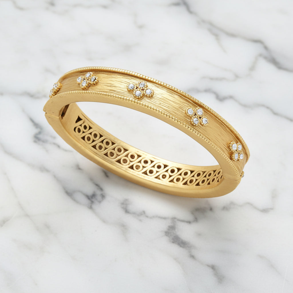 Brushed gold and CZ bracelet by Lorena featuring sparkling cubic zirconia accents on a sleek jewelry design.