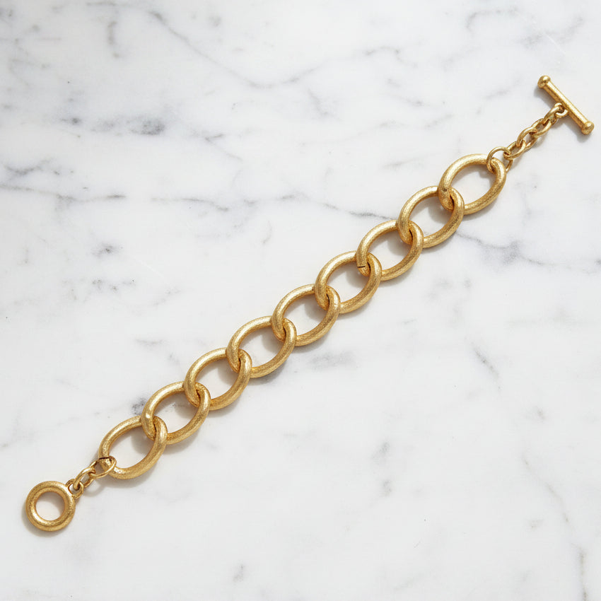 Lorena brushed gold link bracelet with sleek, interconnected chain design on a neutral background.