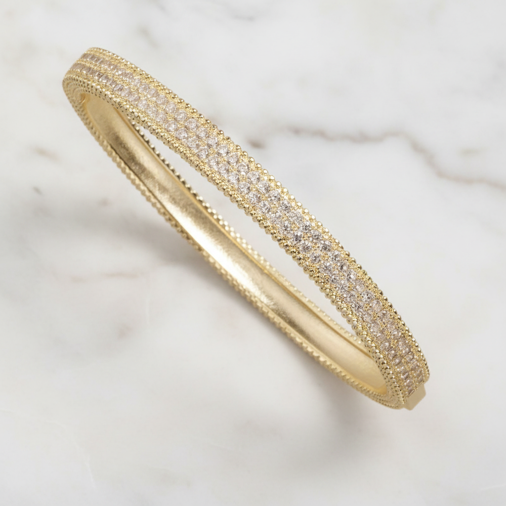 Lorena bangle bracelet with pave CZs, showcasing sparkling cubic zirconia embellishments on a sleek metal band.