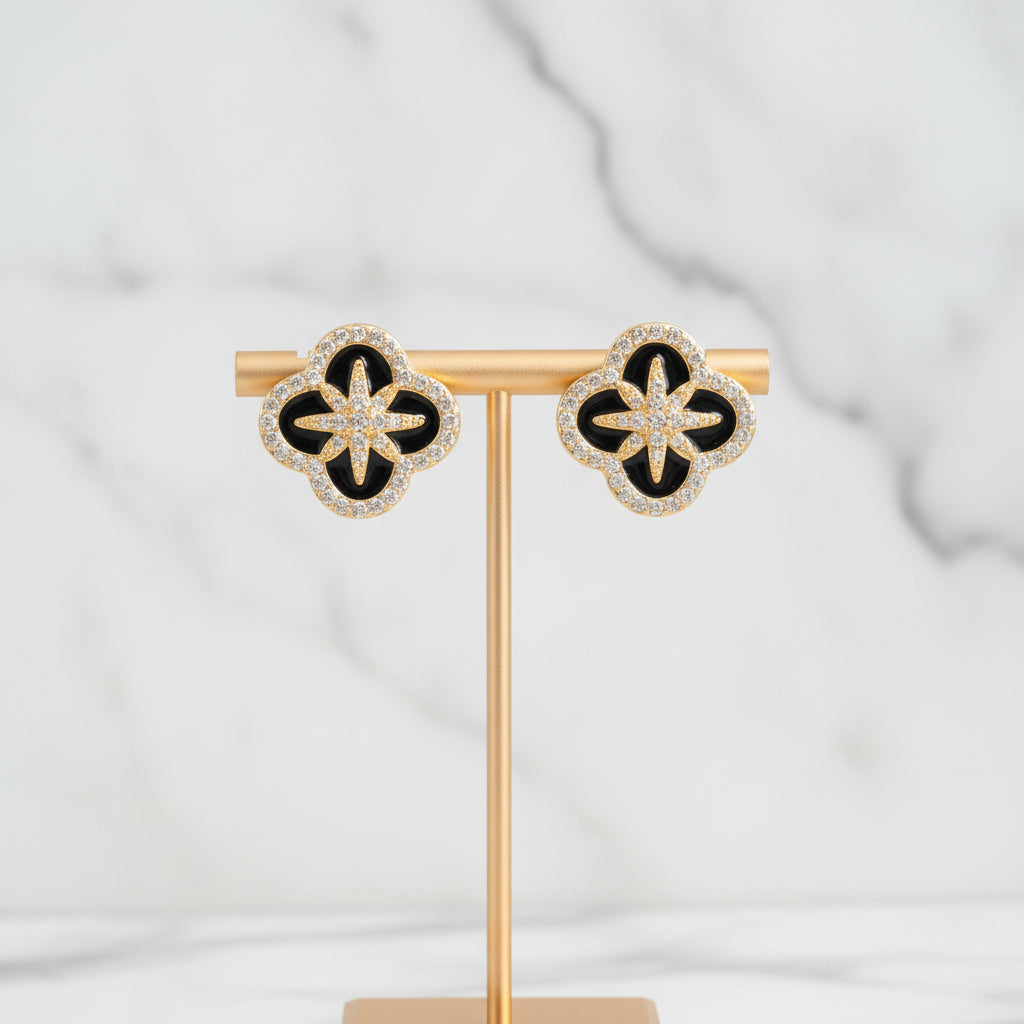 Lorena gold clover CZ stud earring featuring a small, sparkling four-leaf clover design on a metal post.