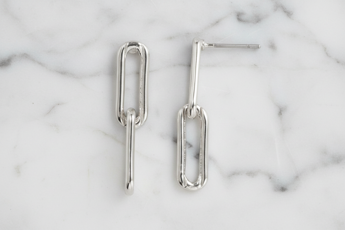 Silver paper clip link earring by Lorena, featuring a sleek, modern design with a polished finish.