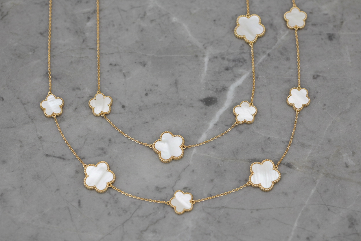 Gold floral necklace by Lorena, 36-inch length with delicate flower details, designed for elegant jewelry styling.