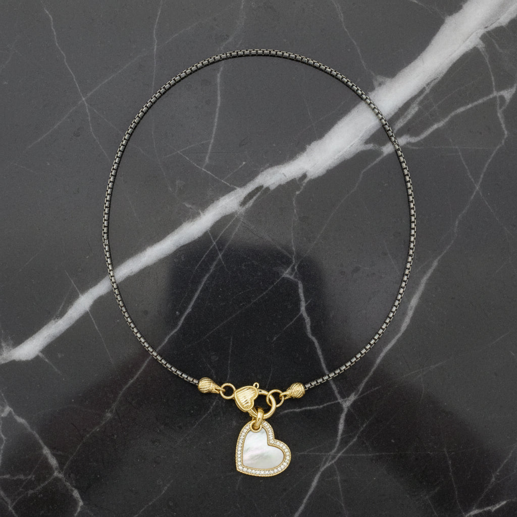 Lorena 17-inch two-tone necklace with a mother-of-pearl heart pendant, showcasing elegant jewelry design and craftsmanship.