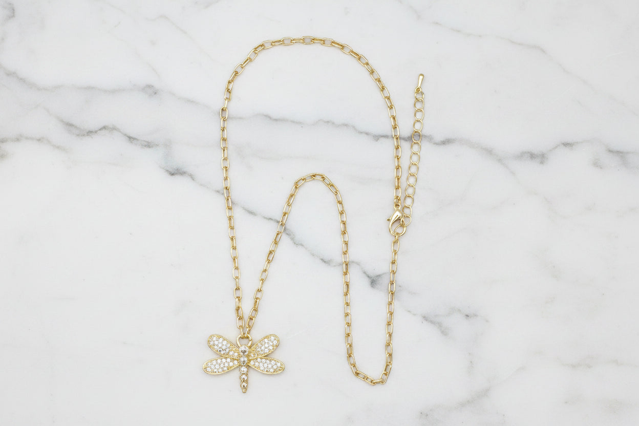 Lorena gold chain necklace featuring a pave dragonfly pendant, showcasing intricate detailing and elegant jewelry design.