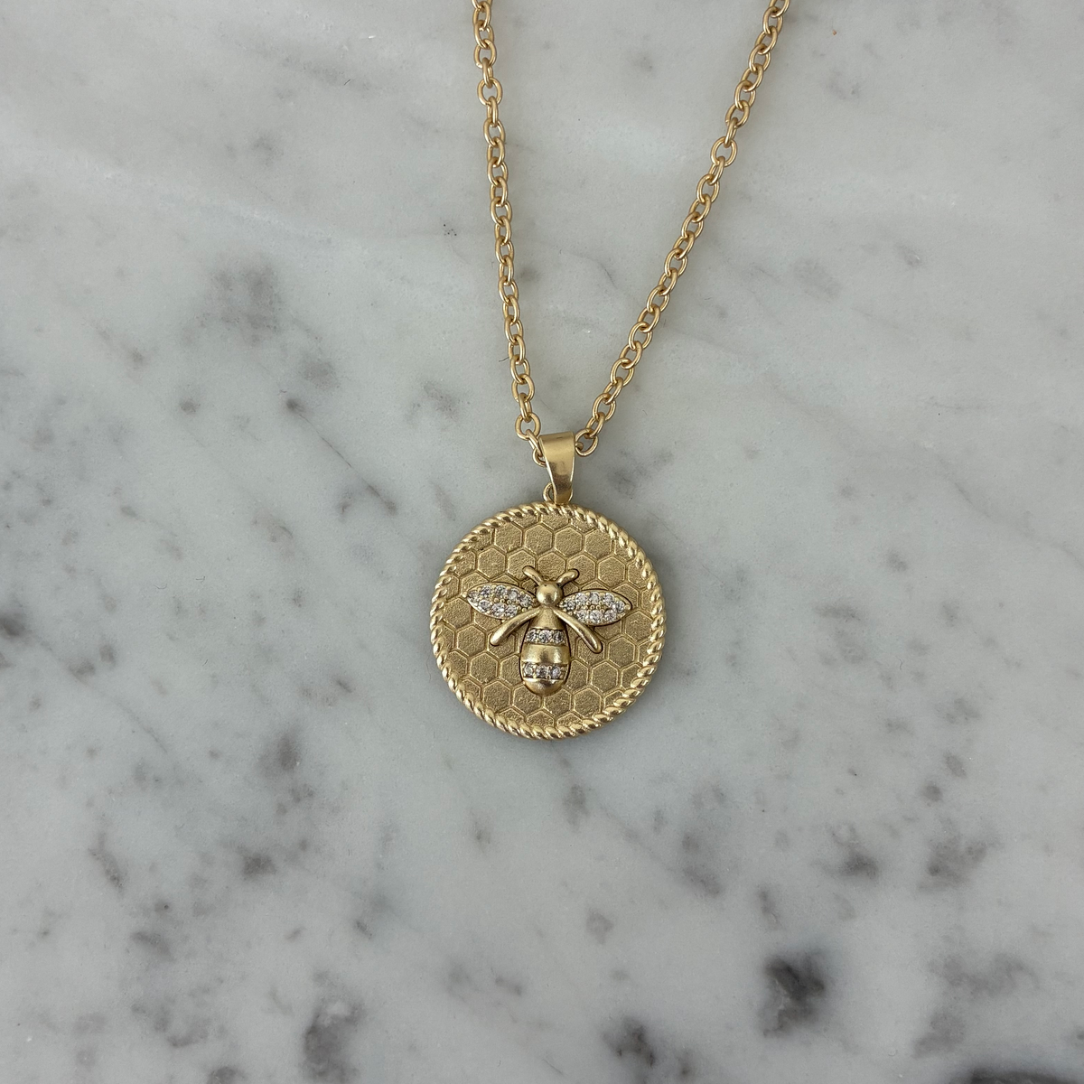 Gold necklace by Lorena with a bee and hive pendant, 16-inch chain, elegant jewelry for nature-inspired style.