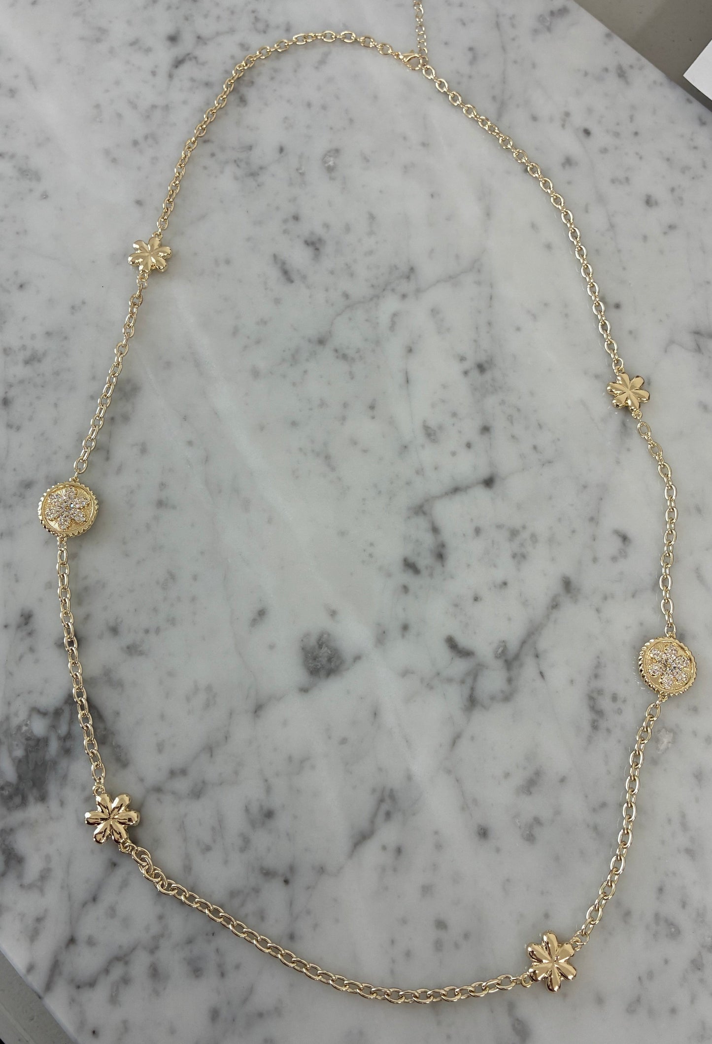 Lorena gold necklace with pave flower design, 36-inch length, showcasing intricate floral details and elegant craftsmanship.