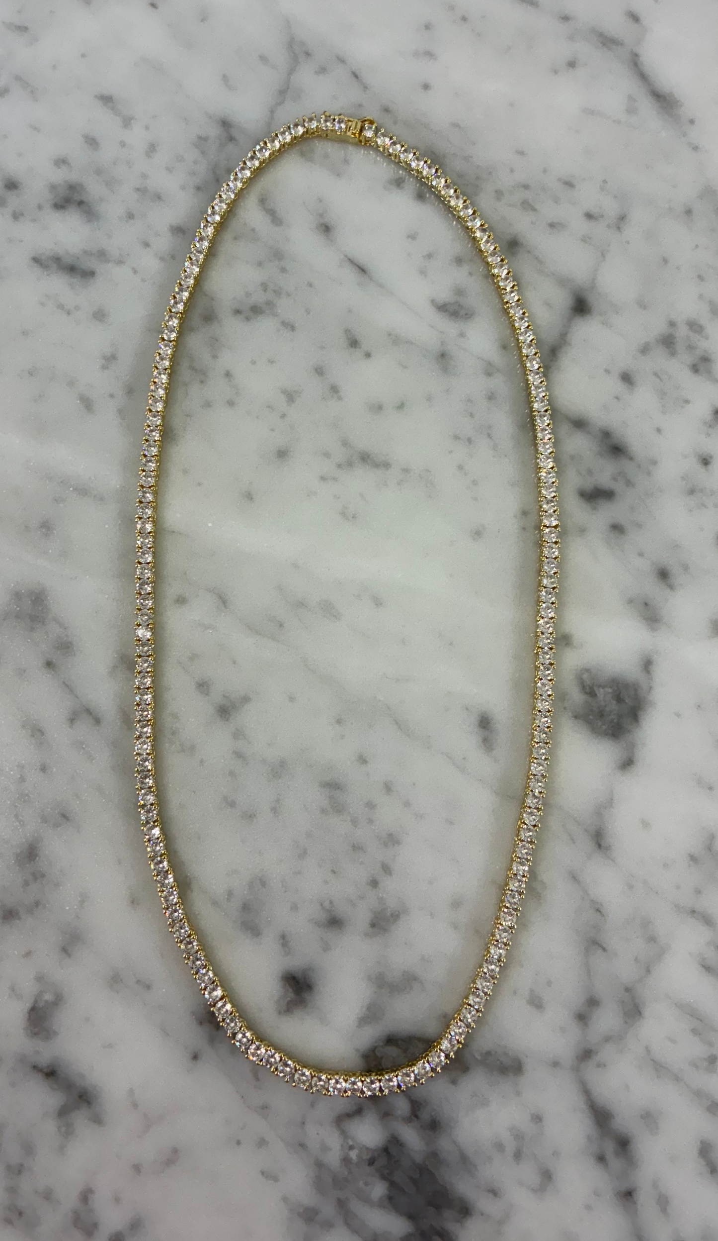 Lorena CZ tennis necklace in 18-inch length featuring sparkling cubic zirconia stones on a sleek chain.