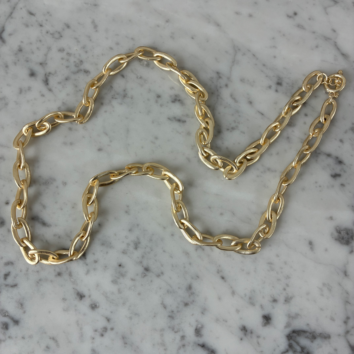 Matte gold oval link necklace by MX featuring large interconnected oval chain links for a stylish accessory.