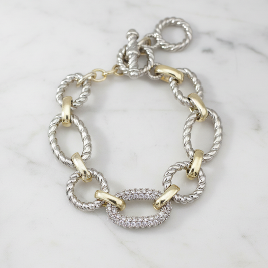 Two-tone cable links oval CZ bracelet by MX featuring linked oval shapes with sparkling cubic zirconia accents.