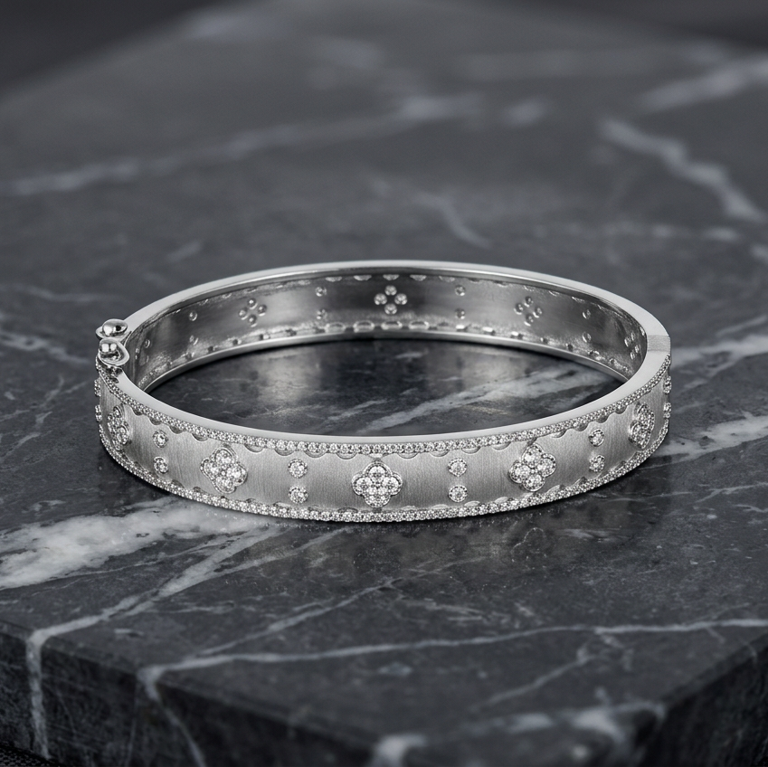 Matte gold skinny CZ flower bracelet by Joseph Anthony Inc. featuring a delicate floral design and sparkling cubic zirconia accents.