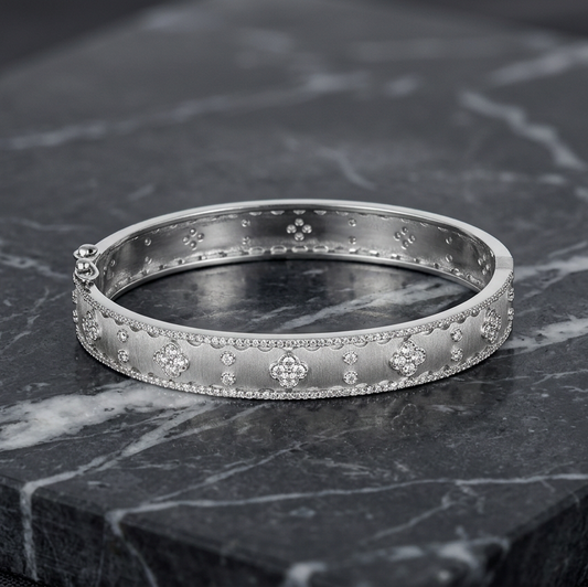 Matte gold skinny CZ flower bracelet by Joseph Anthony Inc. featuring a delicate floral design and sparkling cubic zirconia accents.