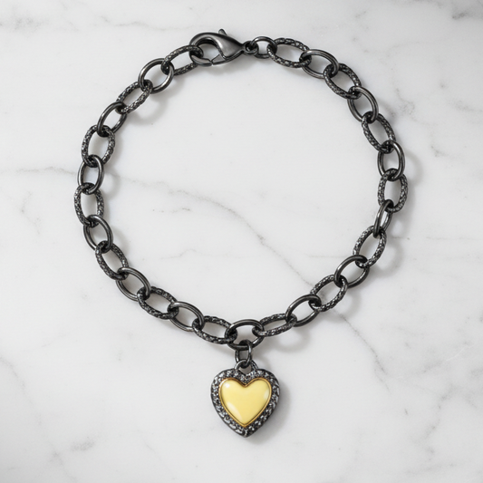 Hematite and gold heart charm bracelet by Joseph Anthony Inc. featuring black hematite beads and a gold heart pendant.