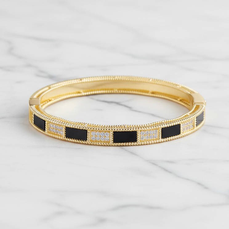 Gold MX bracelet with pave and stone accents, showcasing a stylish and elegant bangle design with detailed embellishments.