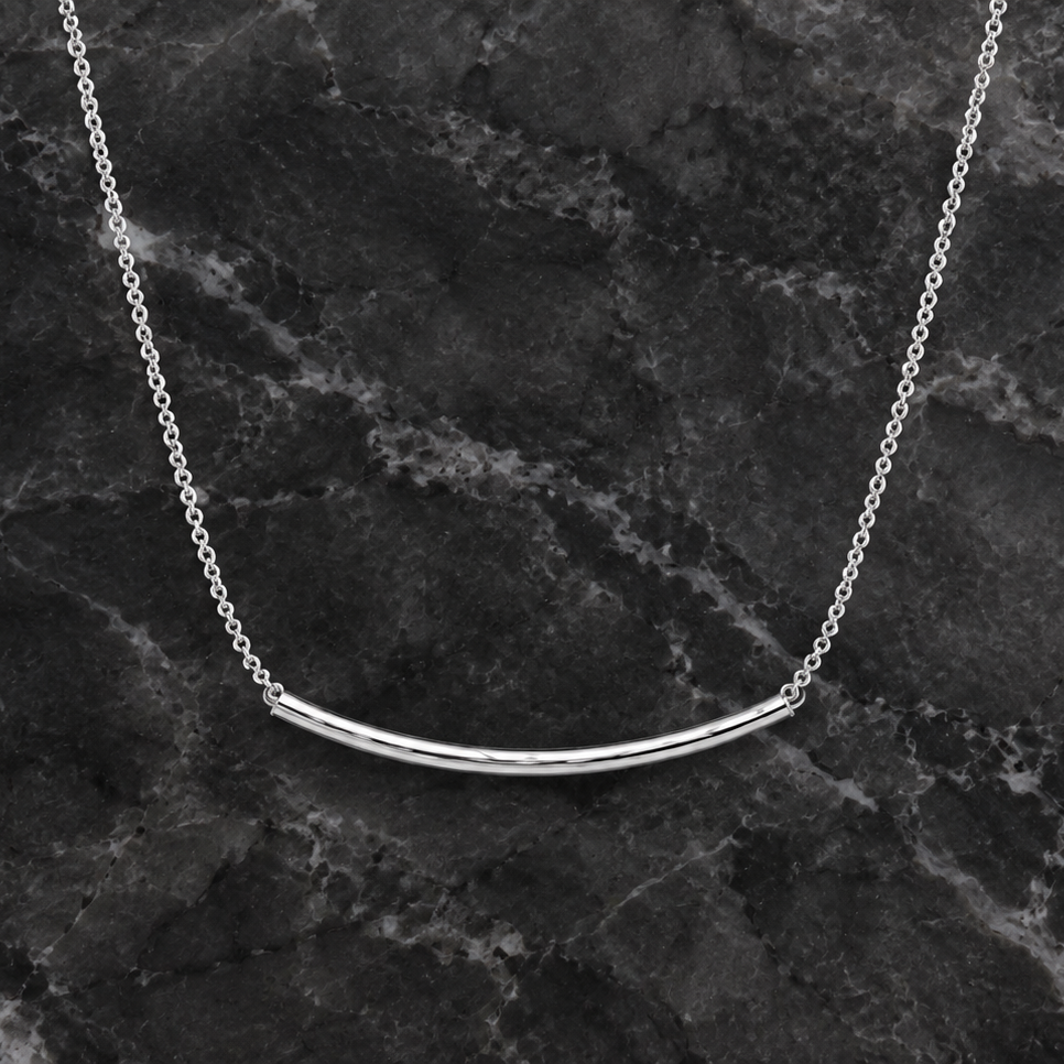 Hammered Smile Necklace by DX Collection, LLC featuring a textured metal pendant on a delicate chain.