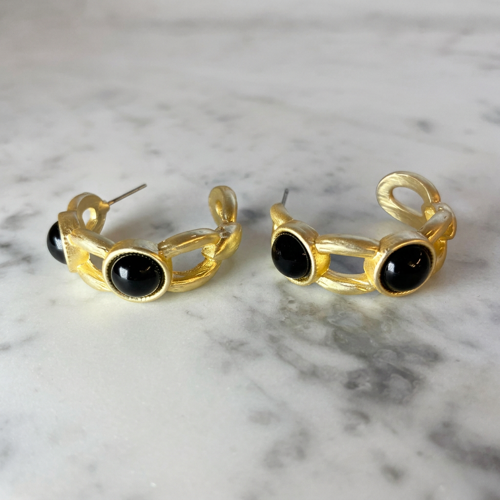 Matte gold 2-stone hoop earring from MX featuring a stylish, modern design with two sparkling stones on a gold hoop.