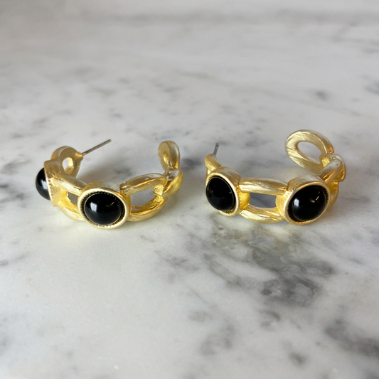 Matte gold 2-stone hoop earring from MX featuring a stylish, modern design with two sparkling stones on a gold hoop.