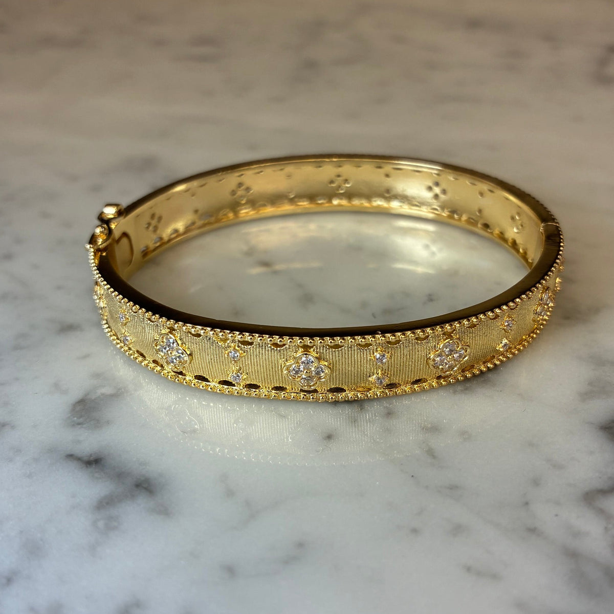 Matte gold skinny CZ flower bracelet by Joseph Anthony Inc. featuring delicate flower-shaped cubic zirconia accents.