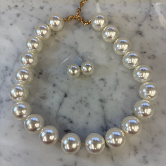 Elegant large pearl necklace set by Mika featuring multiple strands of lustrous white pearls on a white background.