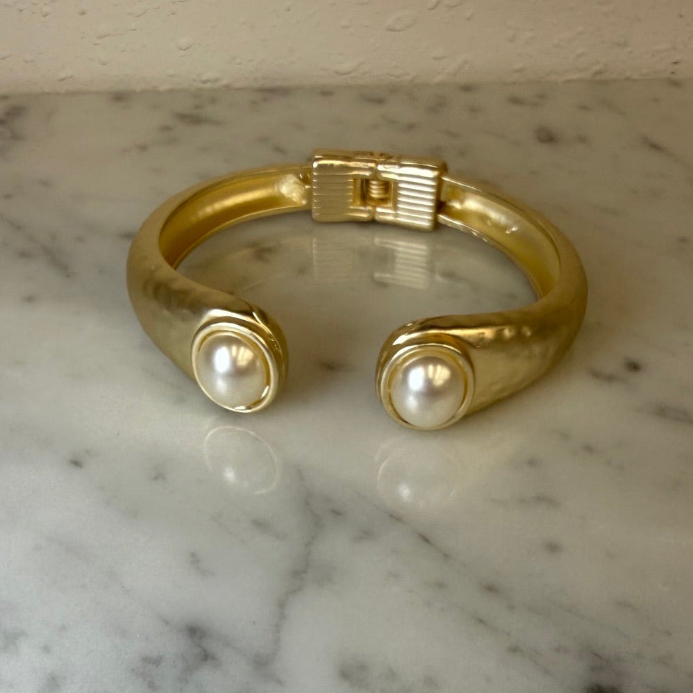 Matte gold MX bracelet with oval stone accent, stylish jewelry accessory featuring a sleek gold bangle design.