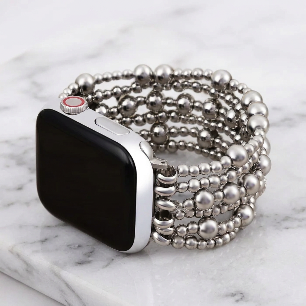 Silver Demure stretch Apple Watch strap by Cape Diablo, close-up of the sleek, flexible watch band on a white background.