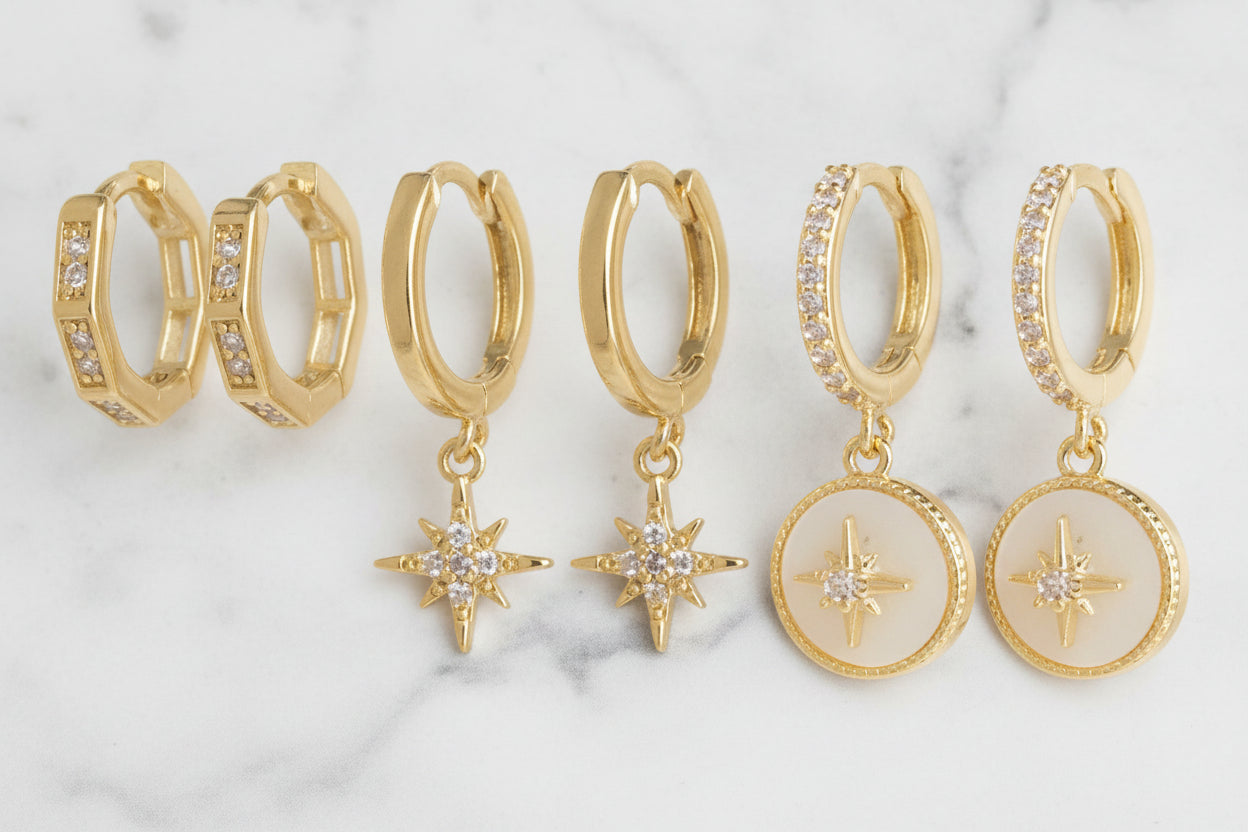 Three-piece gold huggie earring set by DX Collection, LLC, featuring small, stylish hoop earrings for everyday wear.