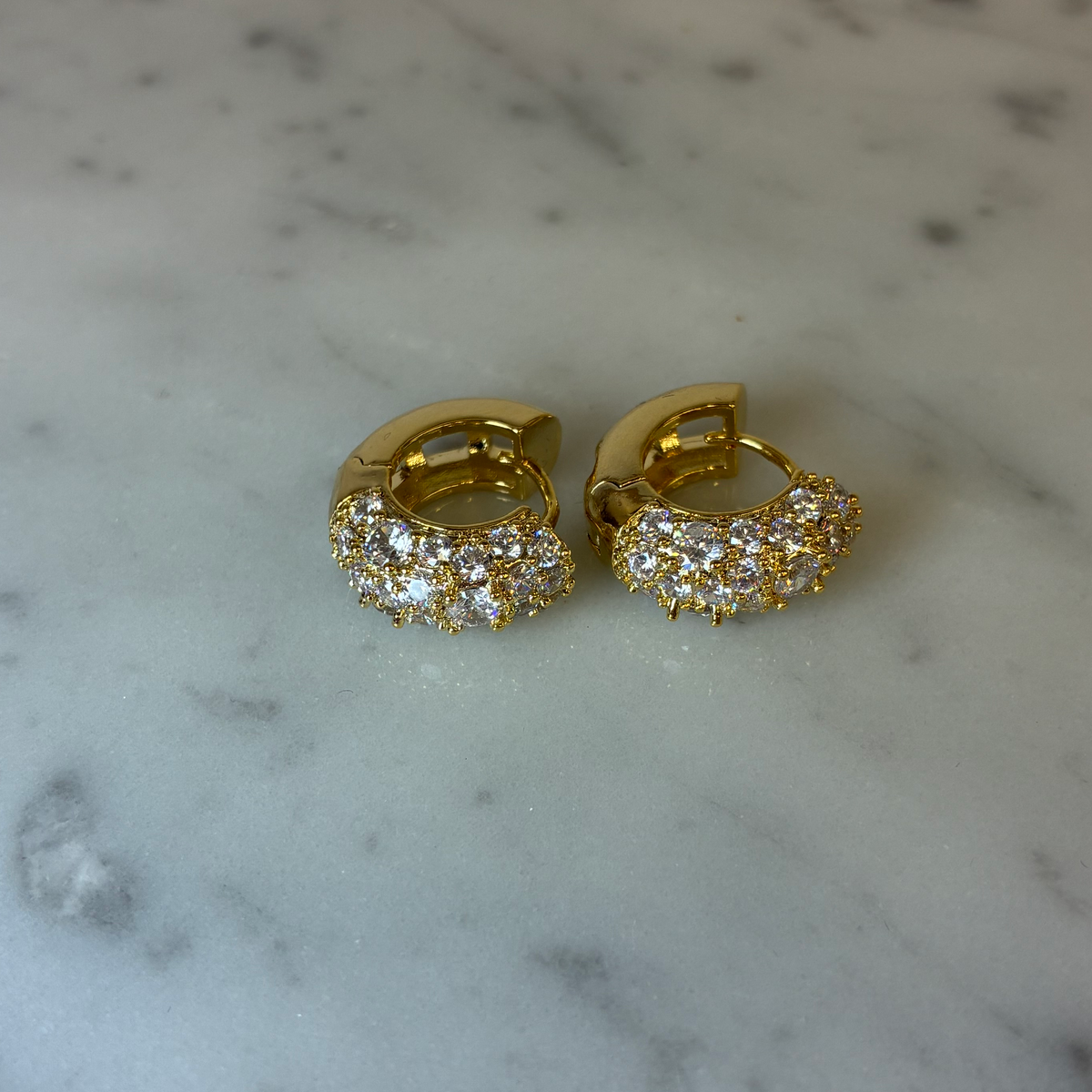 MX Hoop Half CZ Earring featuring a sleek gold hoop with sparkling cubic zirconia accents, stylish and elegant jewelry accessory.