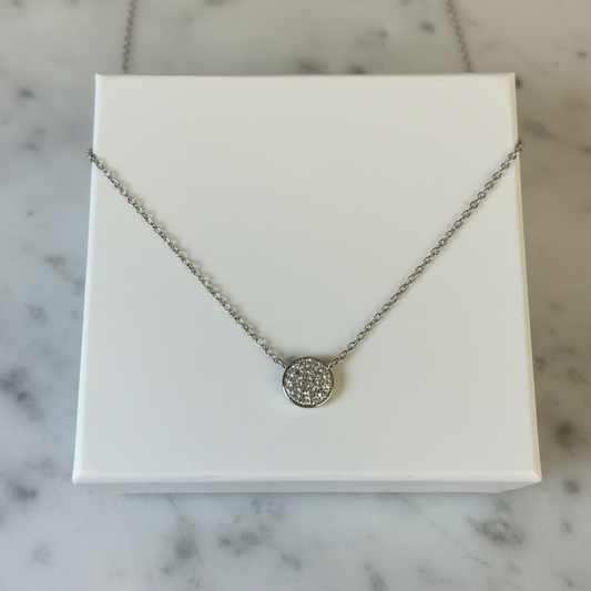 Joseph Anthony Inc. pave round disc necklace featuring a sleek, metallic pendant with sparkling pave detailing on a delicate chain.