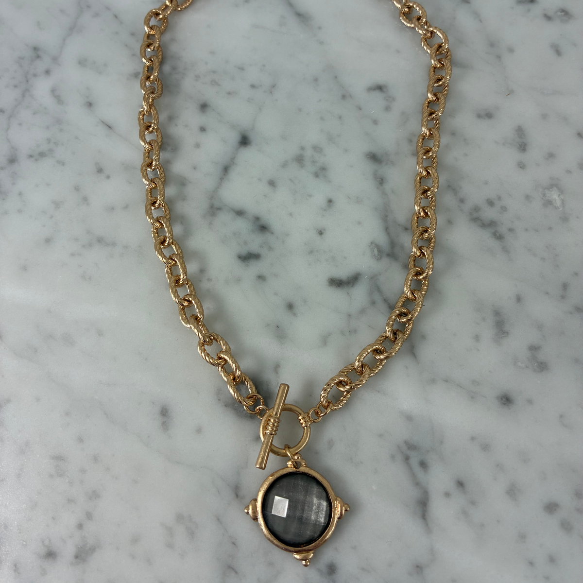 Water & Tree stone pendant necklace with toggle clasp, featuring a smooth, polished stone pendant on a delicate chain.