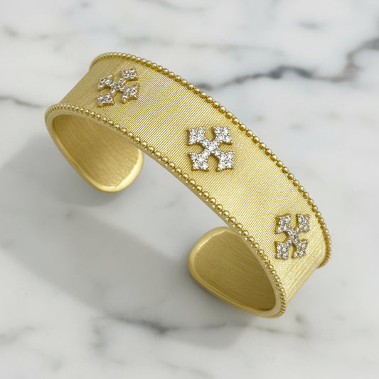 Lorena gold cuff bracelet with pave crosses, featuring intricate cross details and a stylish, modern design.