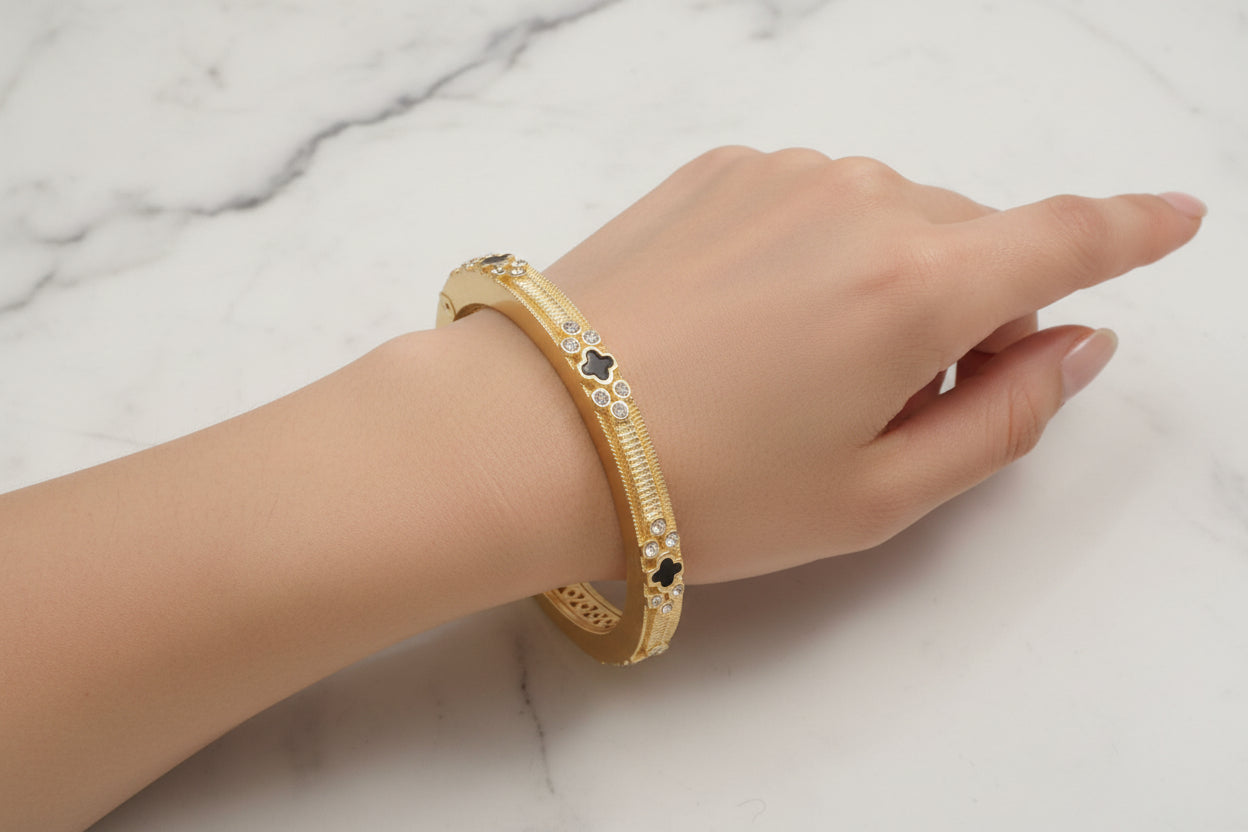 Lorena brushed gold bracelet with cubic zirconia accents and black onyx detailing, elegant jewelry accessory.