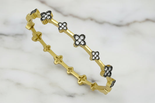 Lorena brushed gold bracelet with hematite flower accents, featuring intricate floral design and elegant craftsmanship.