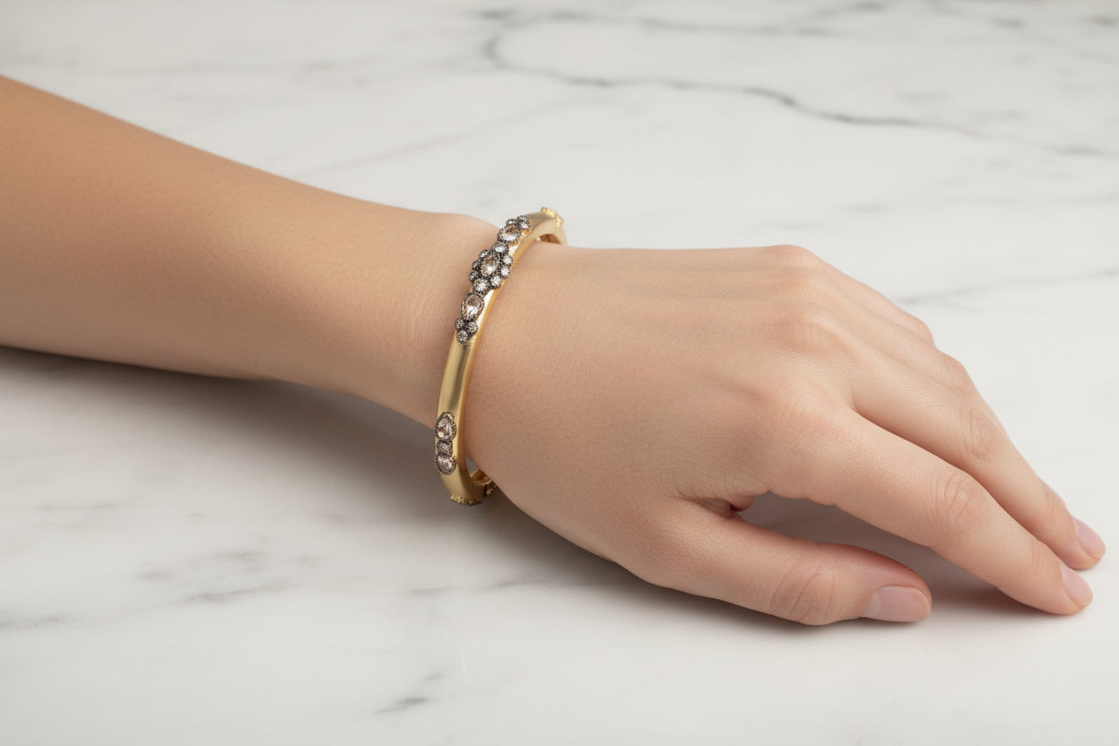 Lorena Fancy Gold and Hematite CZ bracelet with intricate design and sparkling gemstones, stylish jewelry accessory.