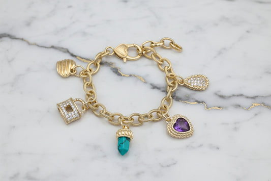 Lorena gold link chain charm bracelet with multiple charms and intricate design, showcasing a stylish jewelry accessory.