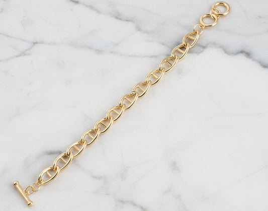 Lorena gold link toggle bracelet with interconnected chain links, stylish and elegant jewelry accessory.