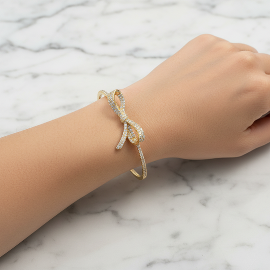 Lorena Dainty CZ Bow Bracelet featuring a delicate design with sparkling cubic zirconia stones and a charming bow detail.