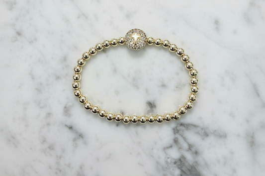Lorena stretch bead bracelet featuring a pave cross design with sparkling beads and a flexible fit.