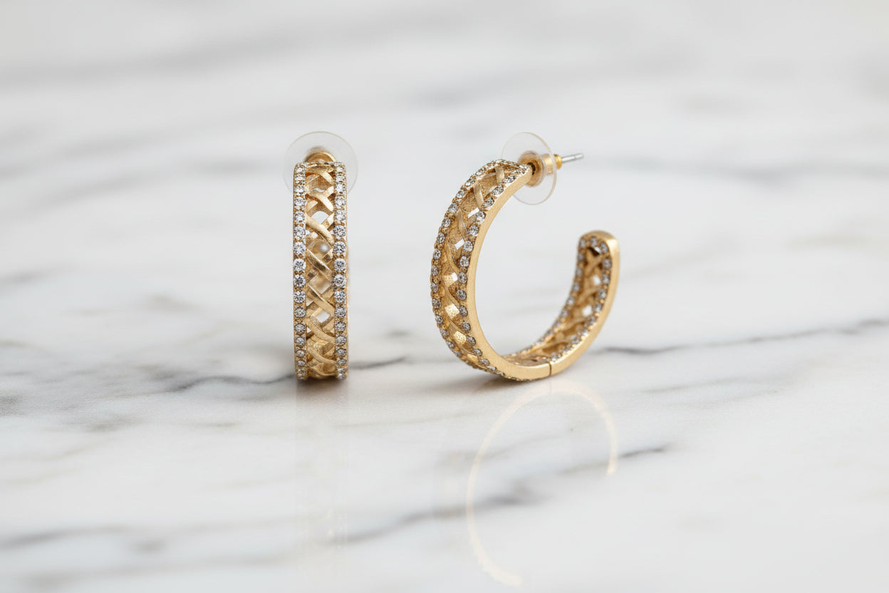 Lorena 1.25-inch matte gold lattice pave hoop earring, showcasing intricate design and sparkling accents.