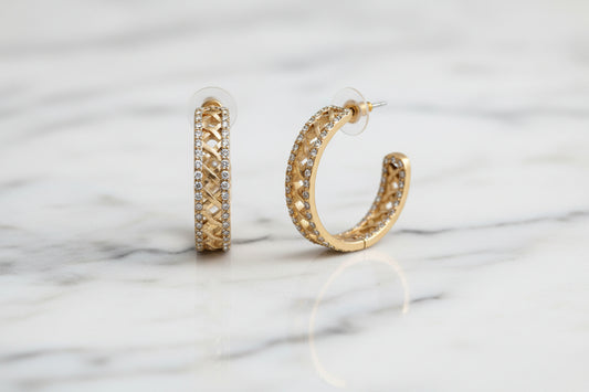 Lorena 1.25-inch matte gold lattice pave hoop earring, showcasing intricate design and sparkling accents.