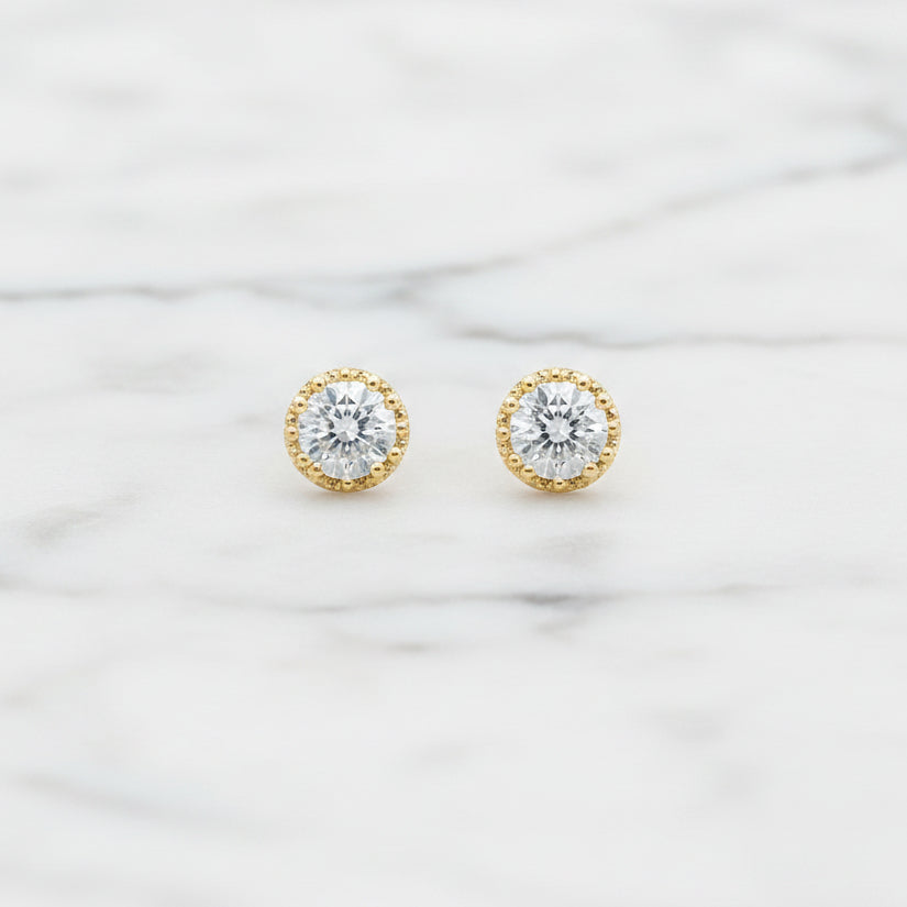 Lorena CZ round gold post earring with a simple, elegant design, featuring sparkling cubic zirconia stones.