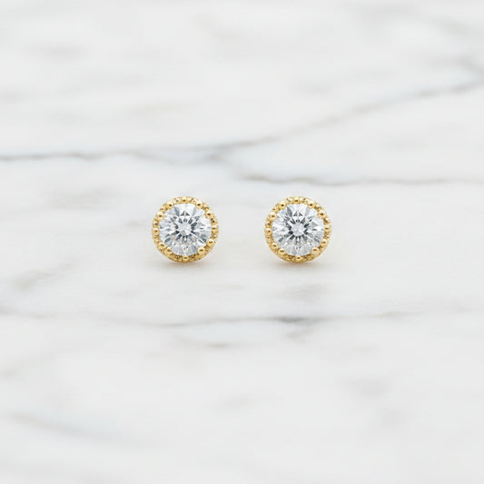 Lorena CZ round gold post earring with a simple, elegant design, featuring sparkling cubic zirconia stones.