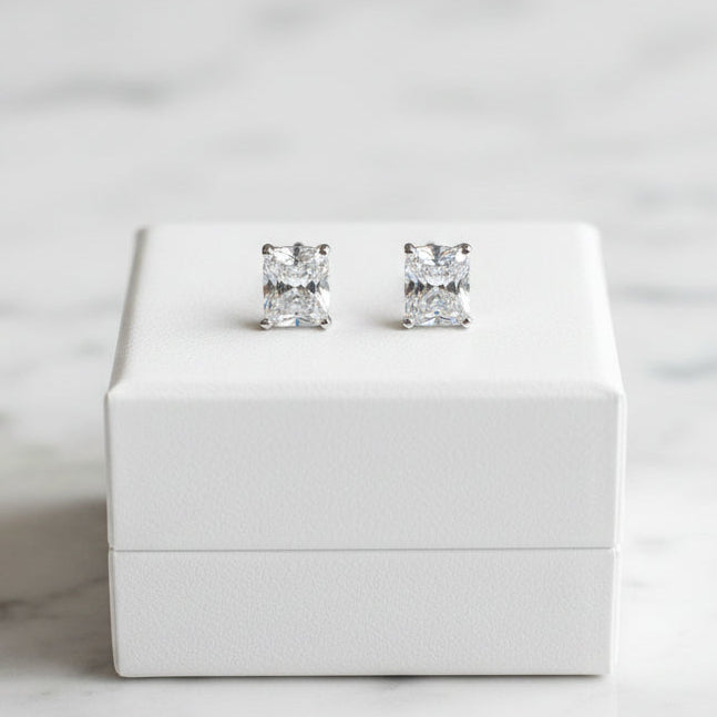 Lorena emerald cut stud earrings with sparkling cubic zirconia stones on a sleek metal setting.