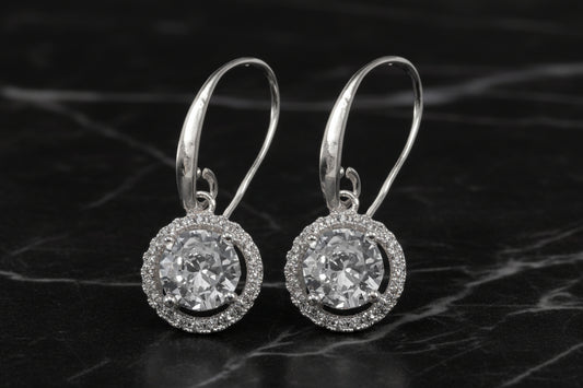 Lorena fancy silver round CZ earring with sparkling cubic zirconia, showcasing a sleek, elegant jewelry design.