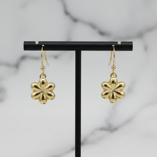Gold dangle flower earring by Lorena featuring a delicate floral design and shiny gold finish.