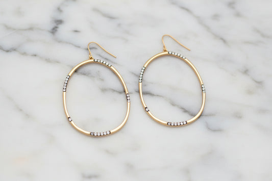 Lorena gold hematite CZ large oval dangle earring showcasing shiny hematite stones and elegant gold-toned metal.