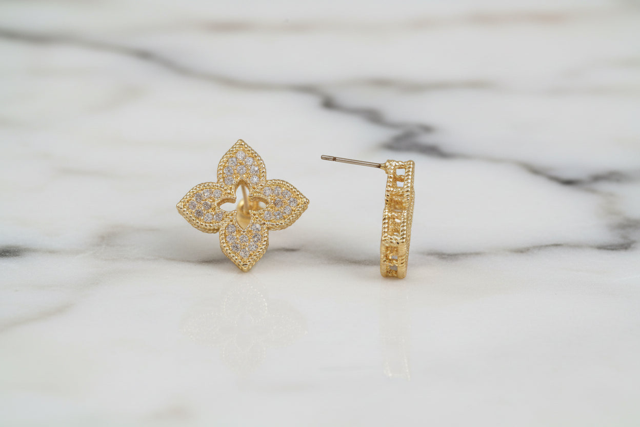 Lorena gold pave clover stud earrings featuring sparkling gold and intricate clover design on a white background.