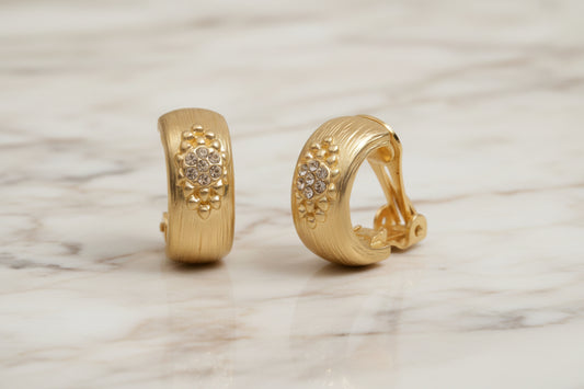 Lorena brushed gold clip earring with CZ cluster, showcasing a stylish and sparkling jewelry piece with intricate detailing.