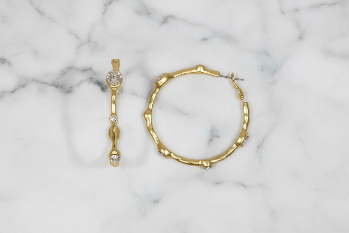 Large gold bamboo CZ hoop earring by Lorena, featuring a stylish design with sparkling cubic zirconia accents.
