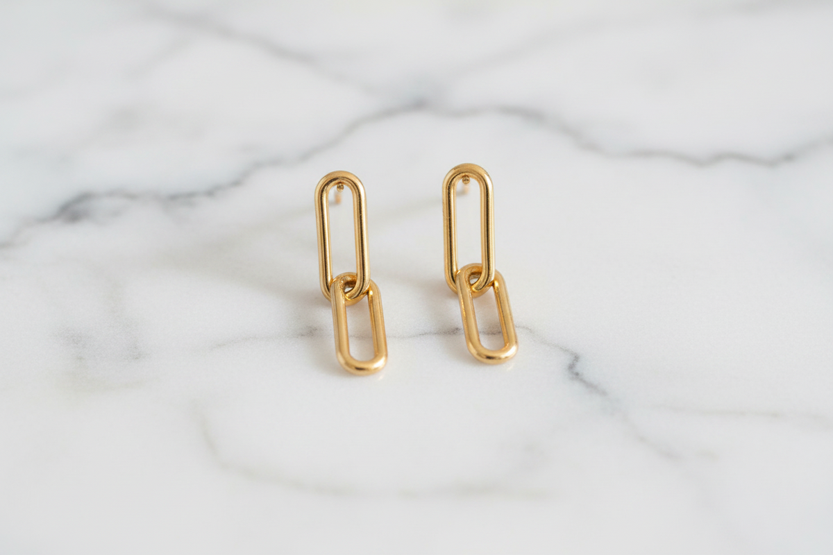 Silver paper clip link earring by Lorena featuring a modern, minimalist design with sleek metal links.